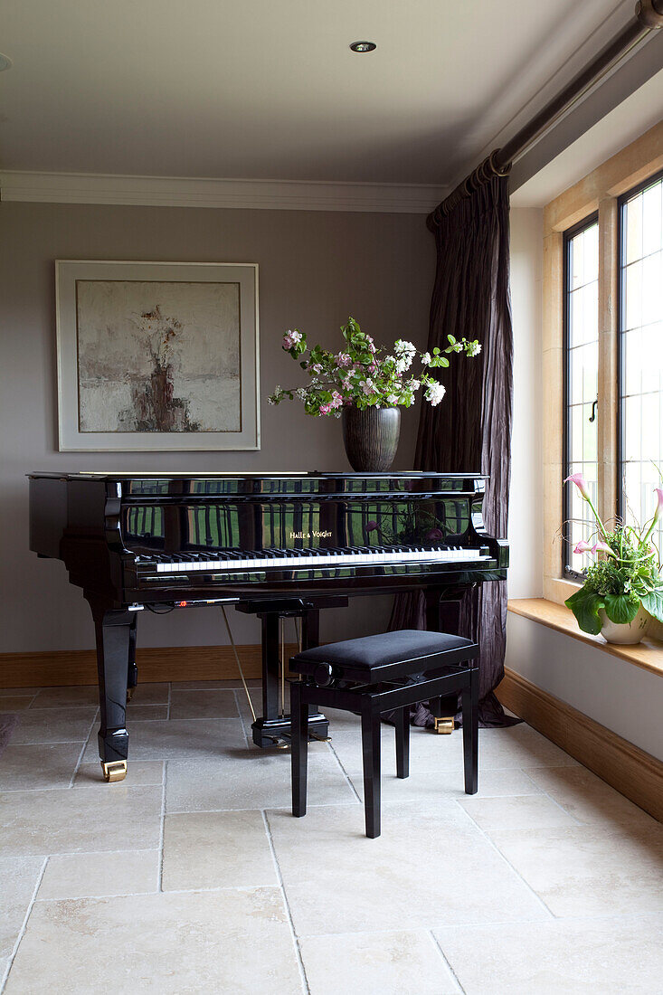 Grand piano at window of Cotswold home UK