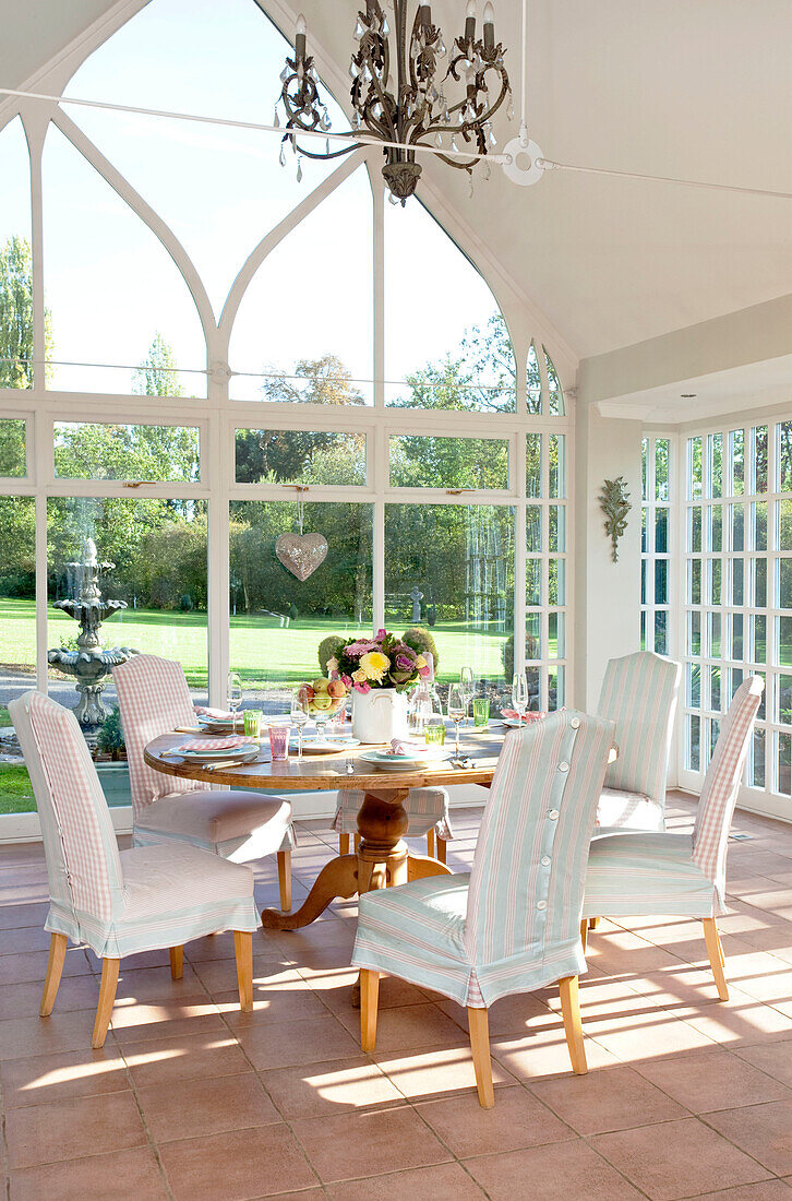 Tisch für sechs Personen in einem Wintergarten mit hohem Dach in einem klassischen Haus in Berkshire, England, Vereinigtes Königreich