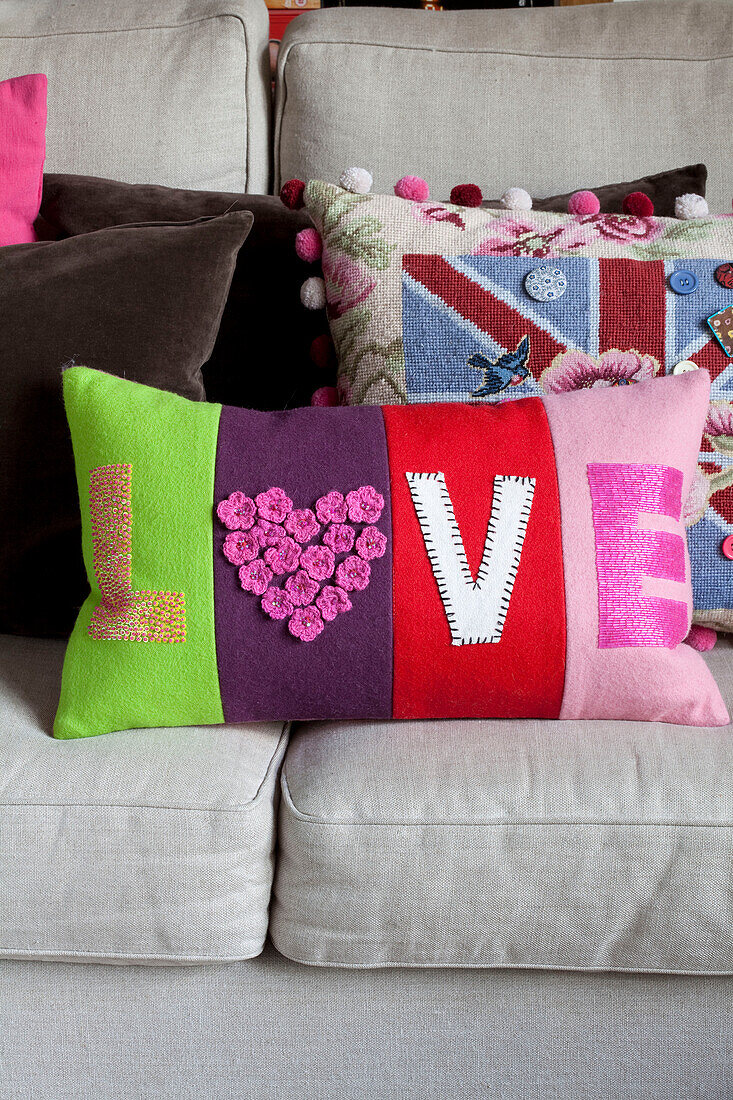 Variety of handmade cushions in contemporary London home, UK