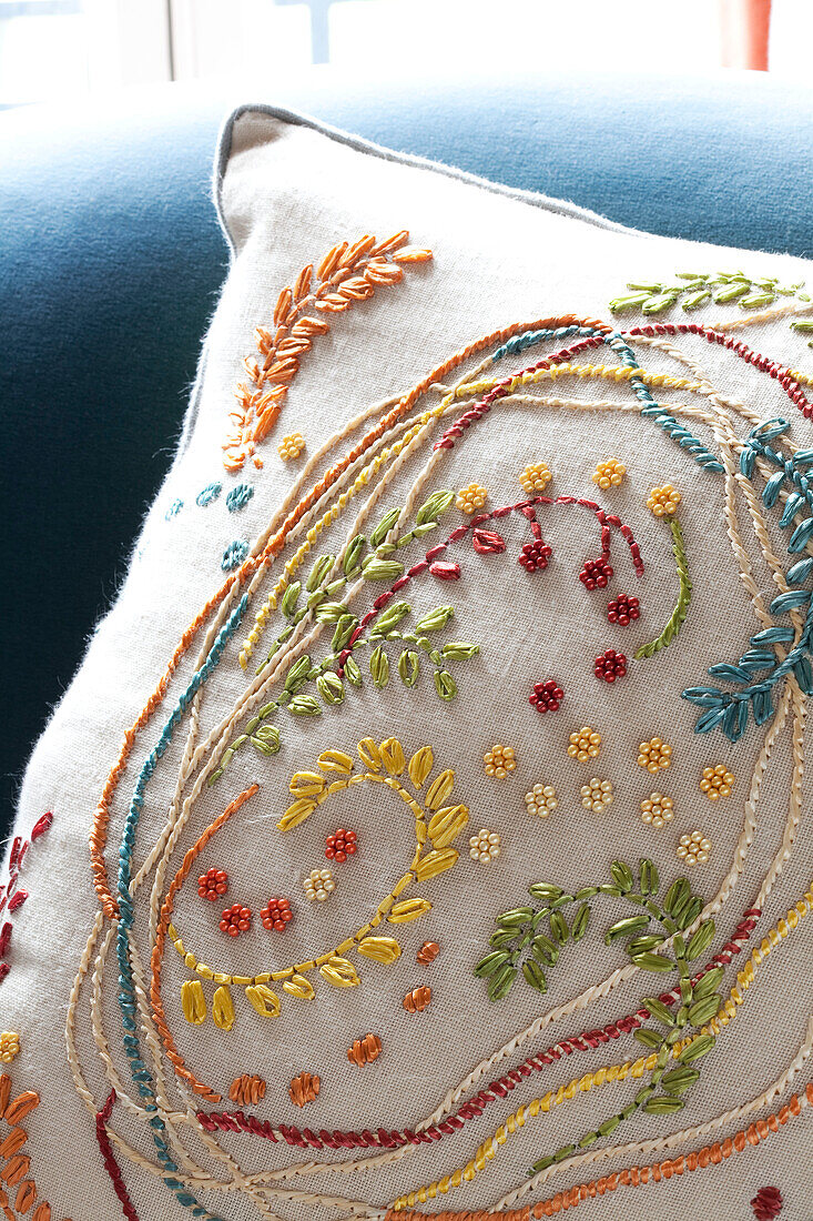 Beaded floral embroidery on cushion in contemporary London home, UK