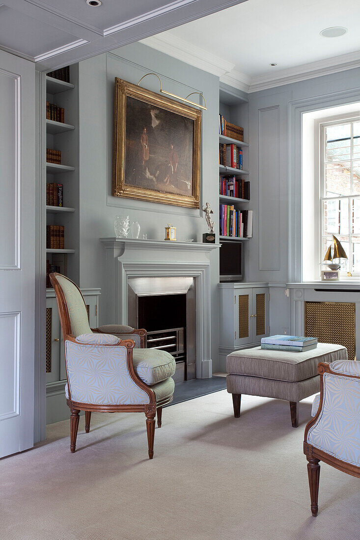 Oil painting above fireplace in living room of contemporary London townhouse, UK