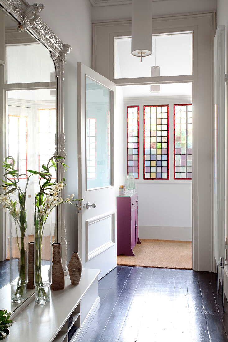 Open door to hallway with mirror and stained glass, Hove, East Sussex, England, UK