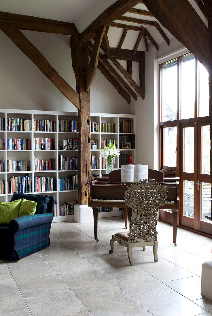 Bookshelf in timber framed piano room Sussex UK