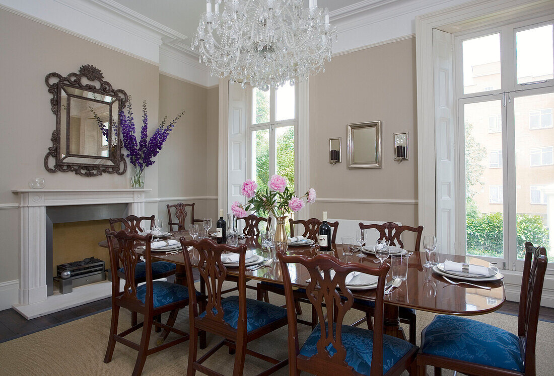 Chandelier above set dining table in London townhouse