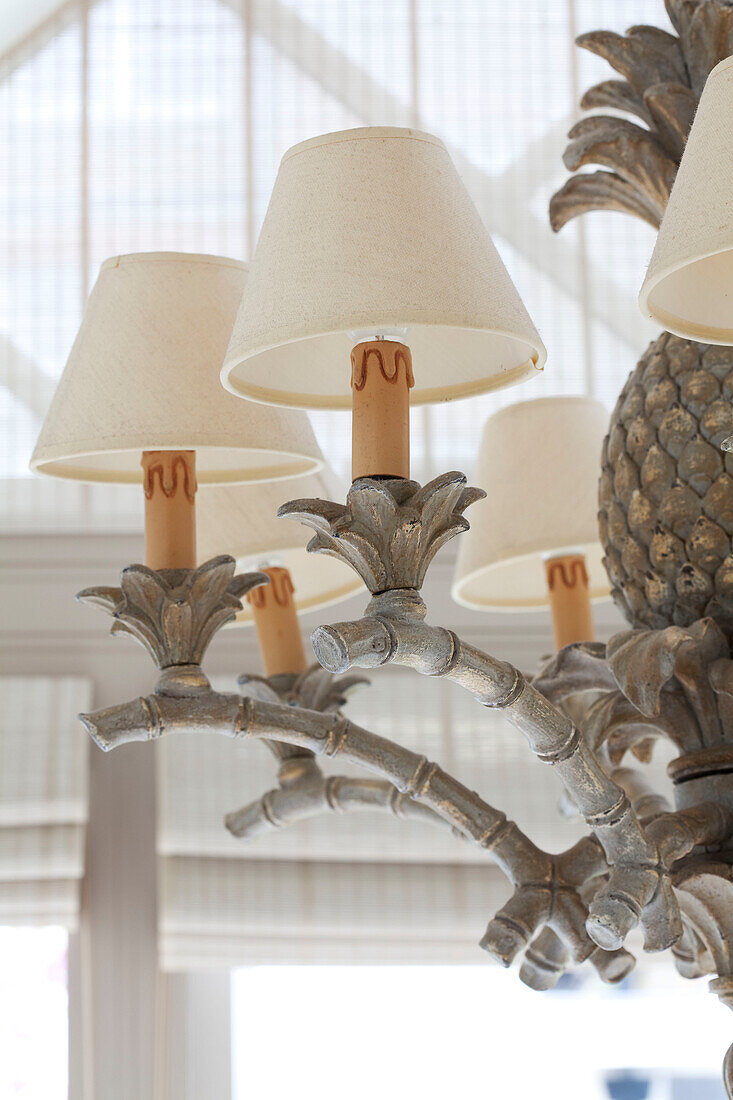 Cream lampshades on pineapple ceiling light in contemporary London townhouse, England, UK