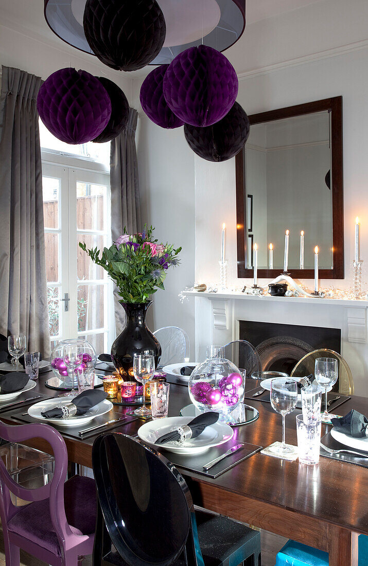Table for eight set in dining room of contemporary London home, UK