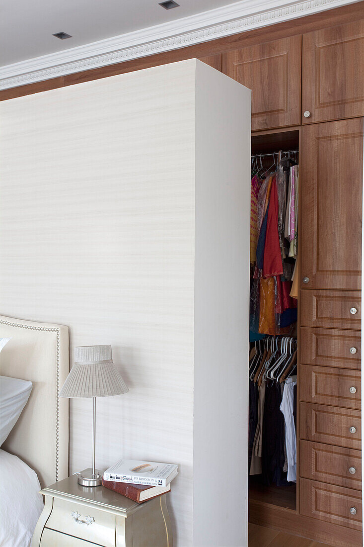 Wall partition concealing clothes storage in contemporary London family home, UK