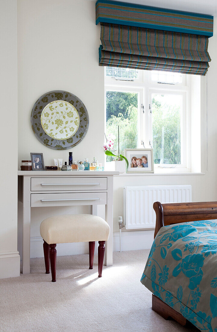 Dressing table at bedroom window with roman blinds in Herefordshire family home England UK