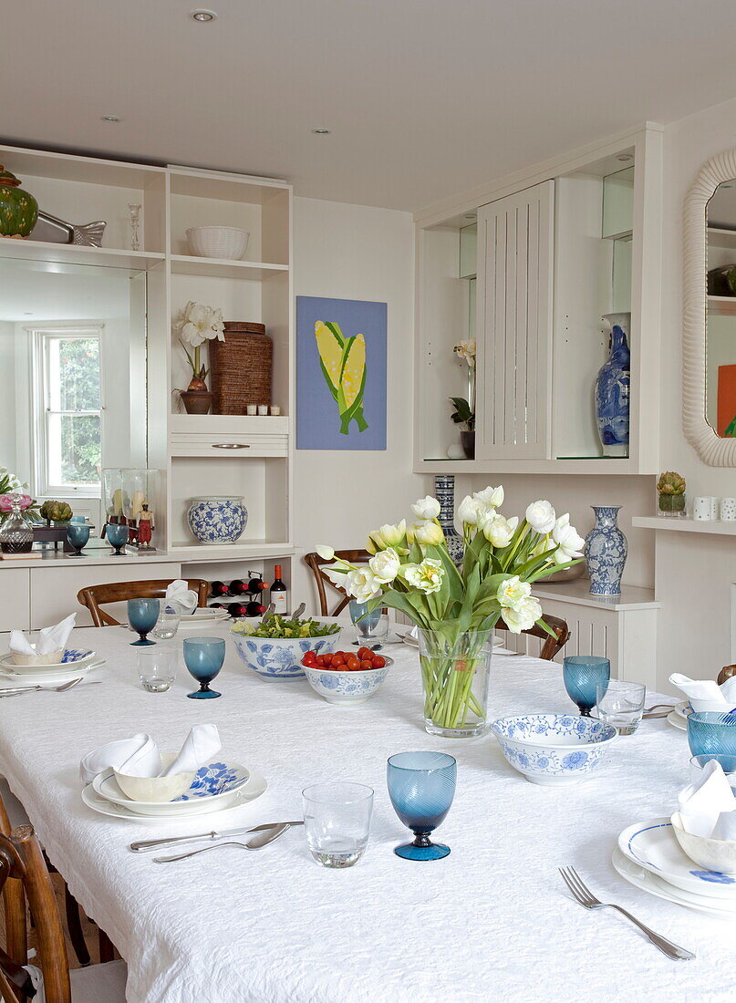 Dining table with cut tulips in London townhouse, England, UK