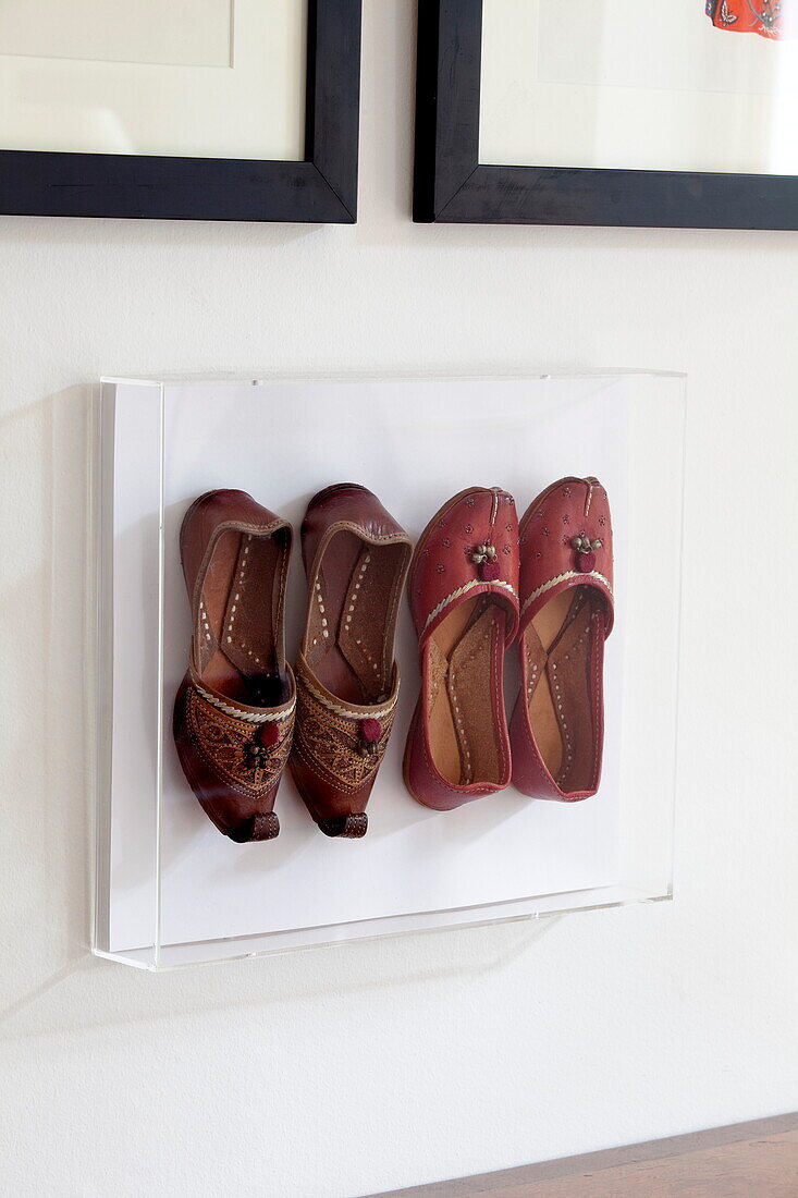 Two pairs of Oriental shoes displayed in London townhouse, England, UK