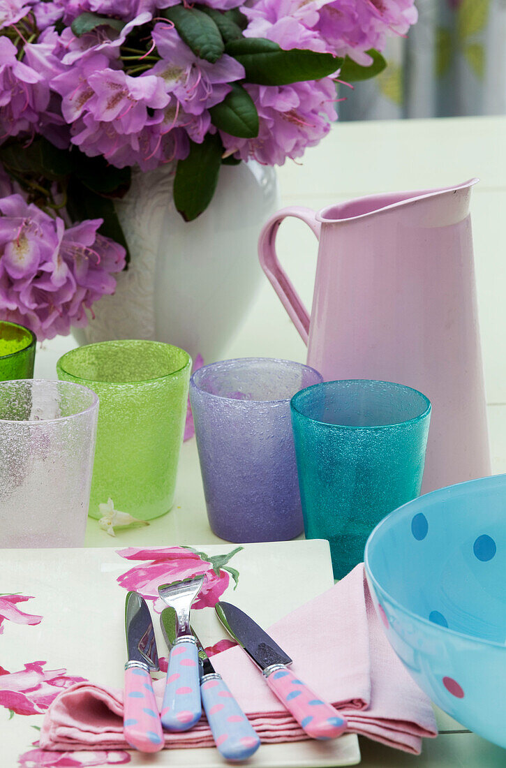 Assortment of glasses with pink jug and knives in Sussex country house, England, UK