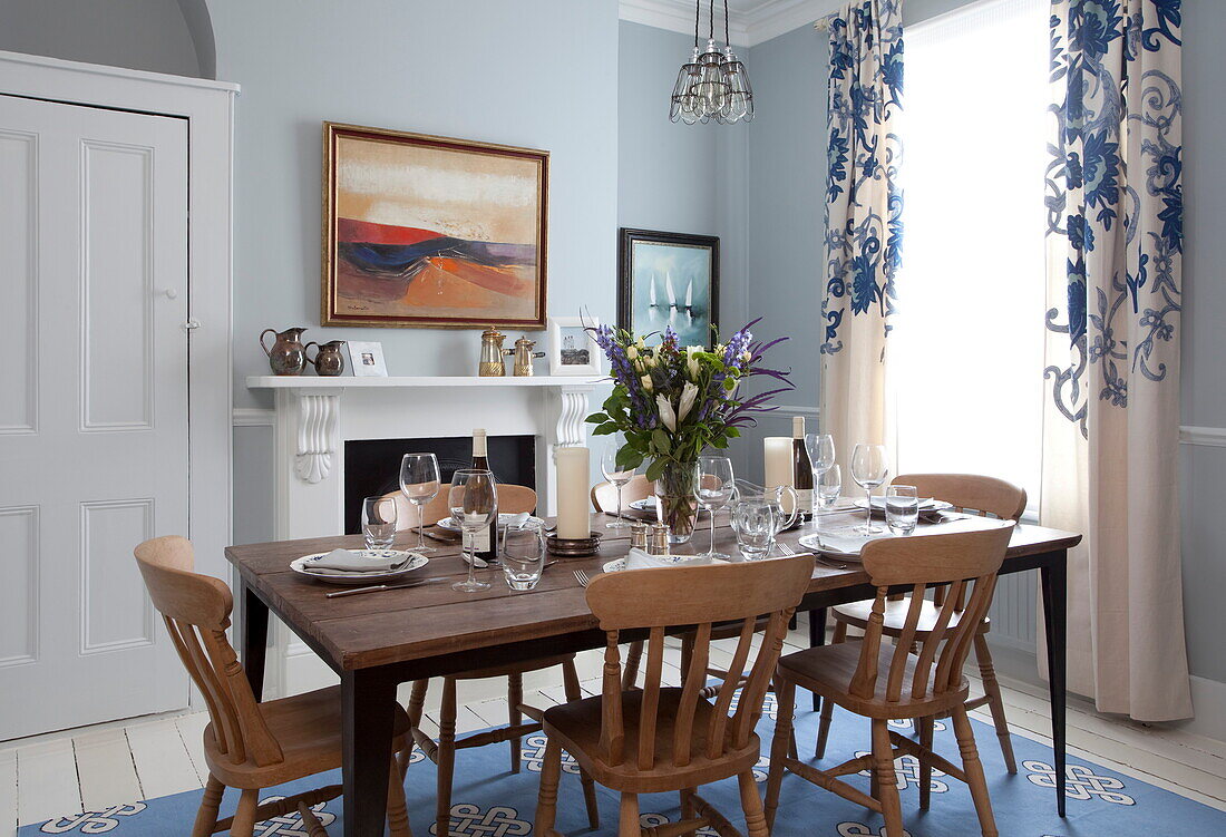 Wooden dining table and chairs in London home, England, UK