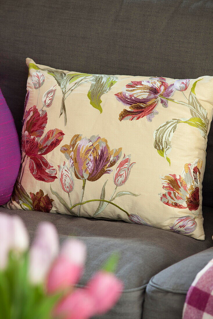 Floral patterned cushion on sofa in Staffordshire farmhouse England UK