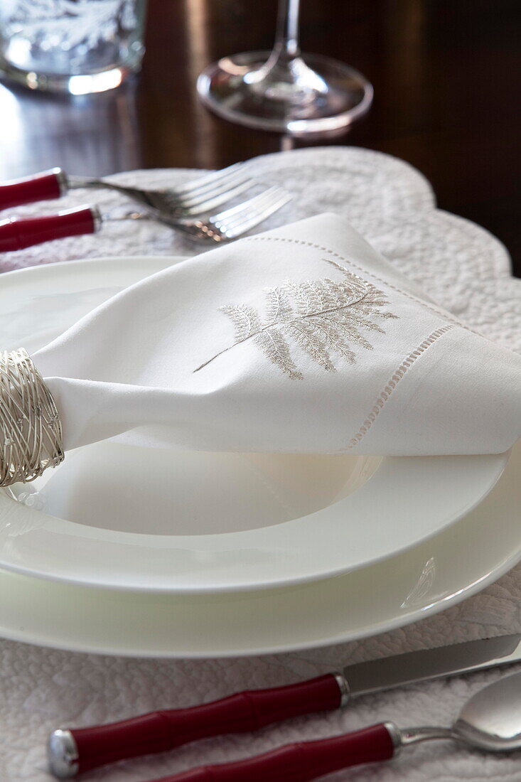 Leaf embroidered motif on napkin at place setting in Staffordshire farmhouse England UK