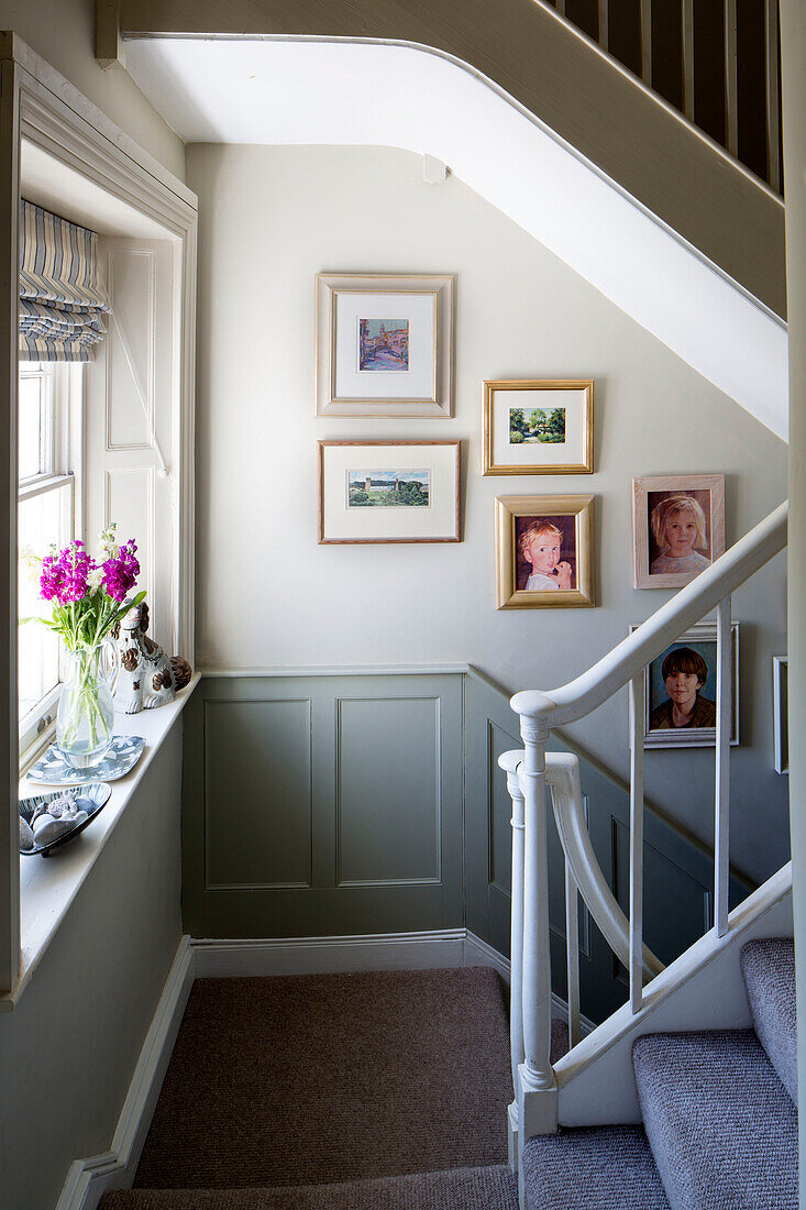 Framed artwork on staircase in Dorset cottage, England, UK
