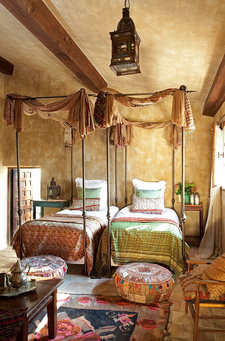 Twin four postered beds in bedroom of French holiday villa