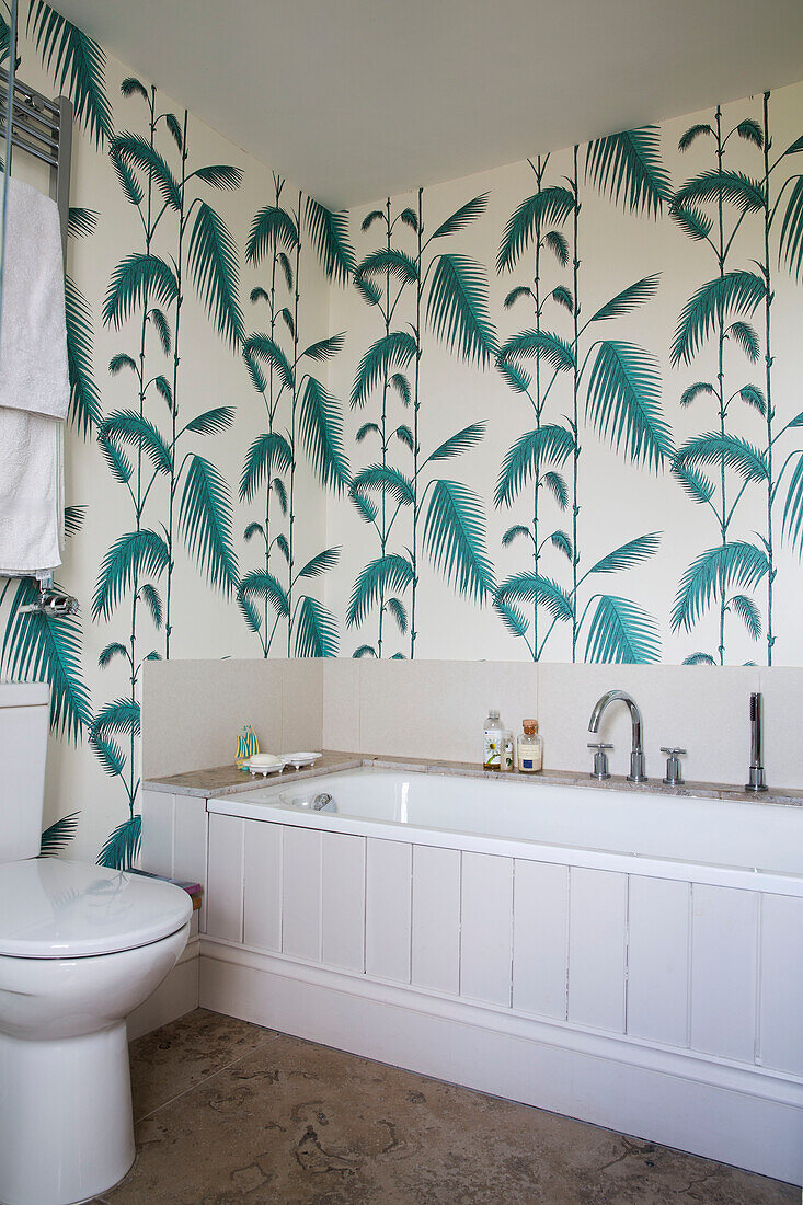 Turquoise leaf patterned wallpaper in white bathroom of Herefordshire home, England, UK