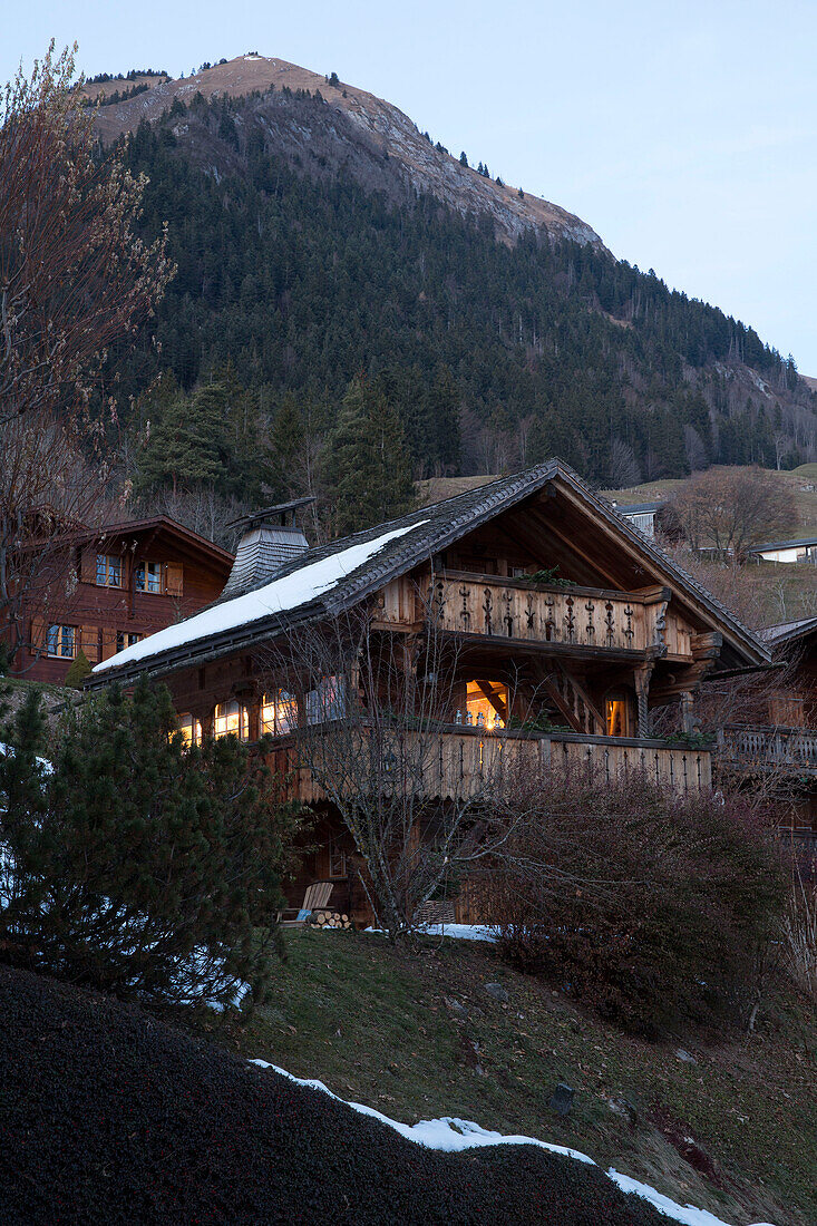 Lit exterior of mountain chalet, Chateau-d'Oex, Vaud, Switzerland