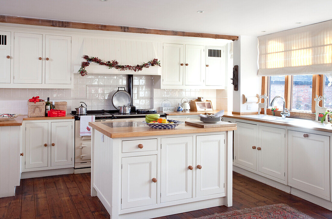 White fitted kitchen with island unit in Chilterns home, England, UK
