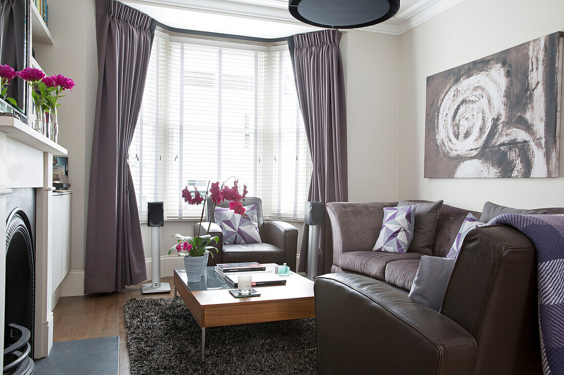 Venetian blinds in bay window of contemporary living room in Brighton home, East Sussex, England, UK