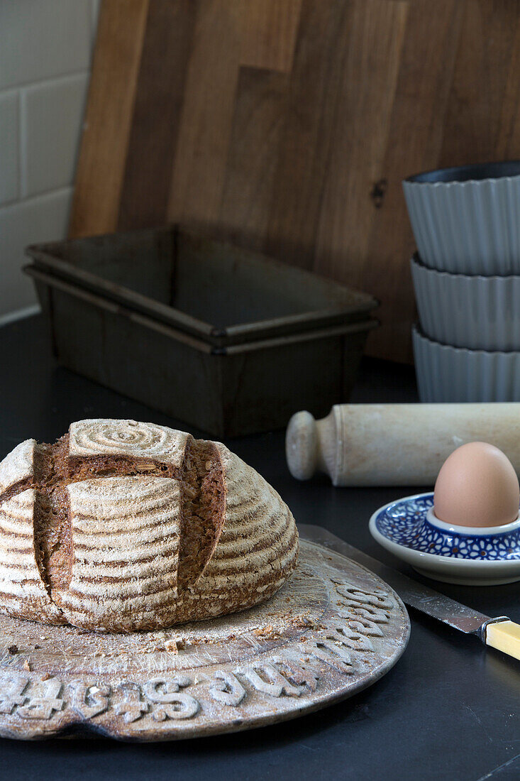 Boiled egg and crusty loaf with baking trays in Ceredigion farmhouse Wales UK