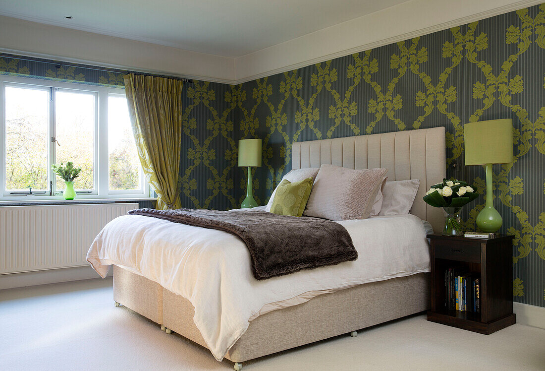 lime green pattered wallpaper with matching lamps at bedside in Berkshire, home, England, UK