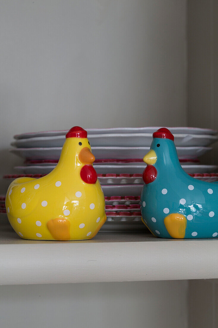 Blue and yellow spotted hens with plates on shelf in Shoreham by Sea home   West Susses   England   UK