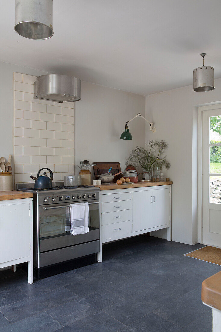 Stainless steel oven with metal lampshades in Presteigne cottage Wales UK