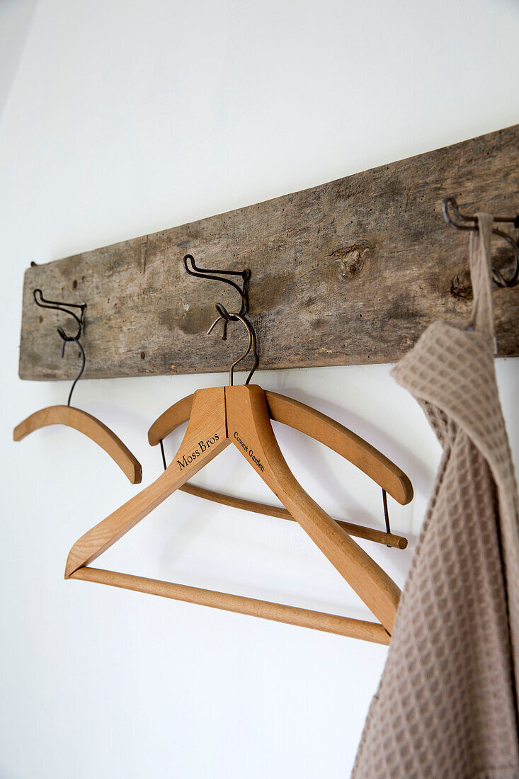 Wooden clothes hangers on hooks in Presteigne cottage Wales UK