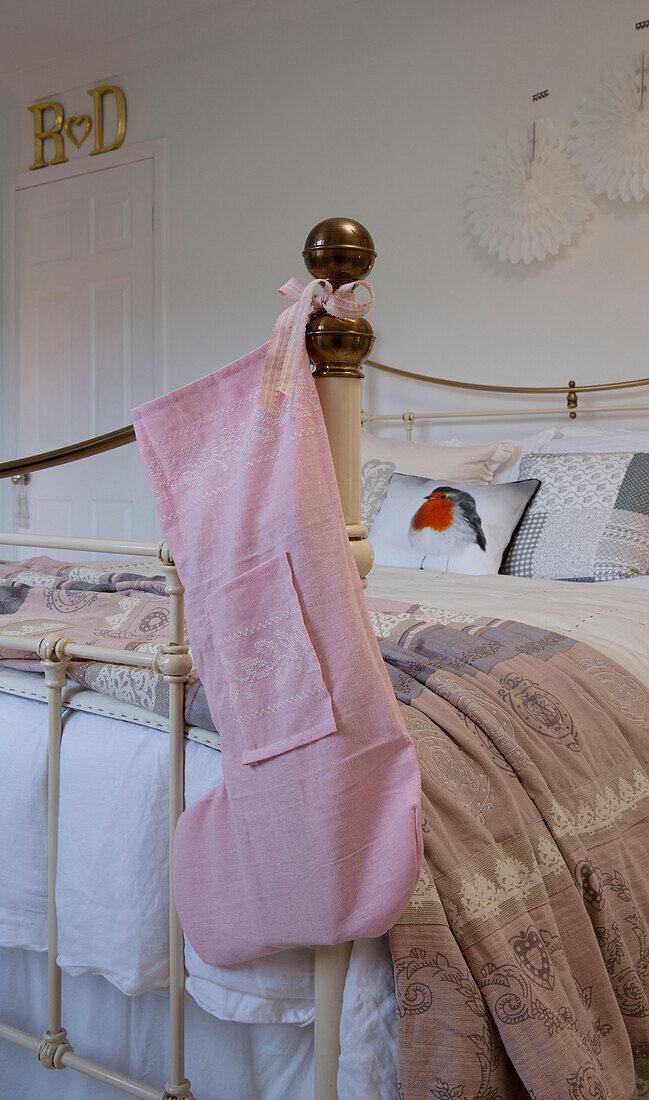Pink Christmas stocking on footboard of Laughton bed  Sheffield  UK