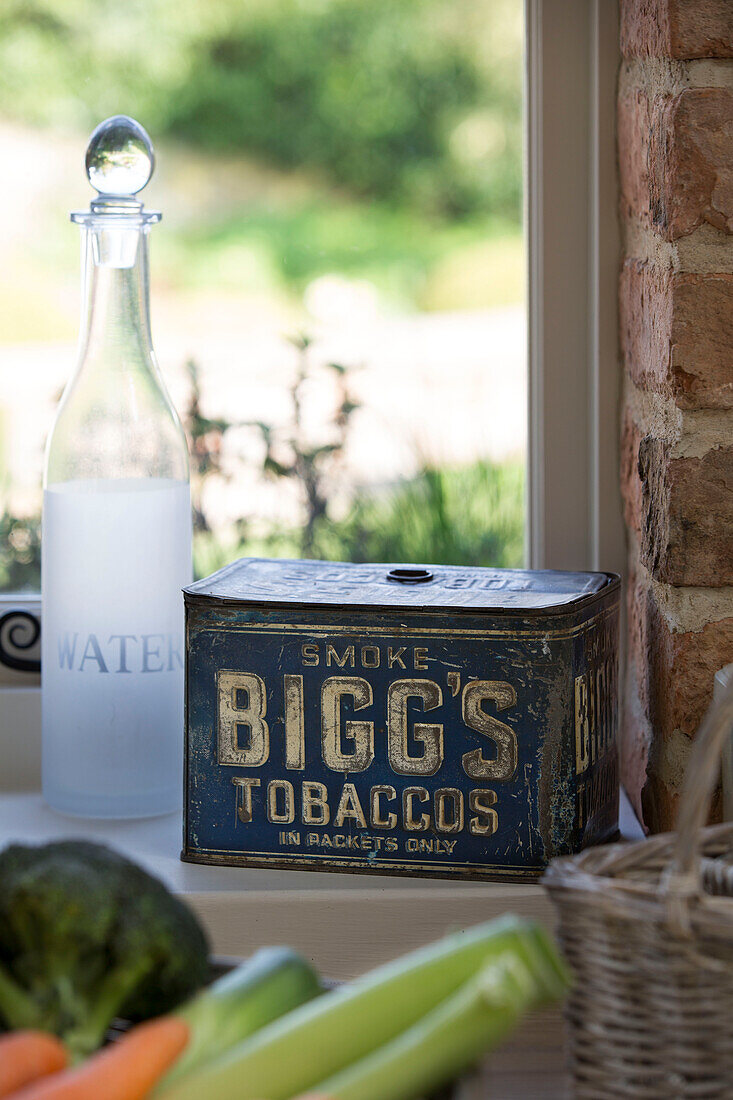 Water bottle and tobacco tin on East Dean windowsill  West Sussex  UK
