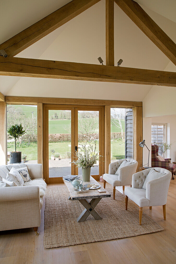 White sofa and matching chairs with coffee table in East Dean conservatory  West Sussex  UK