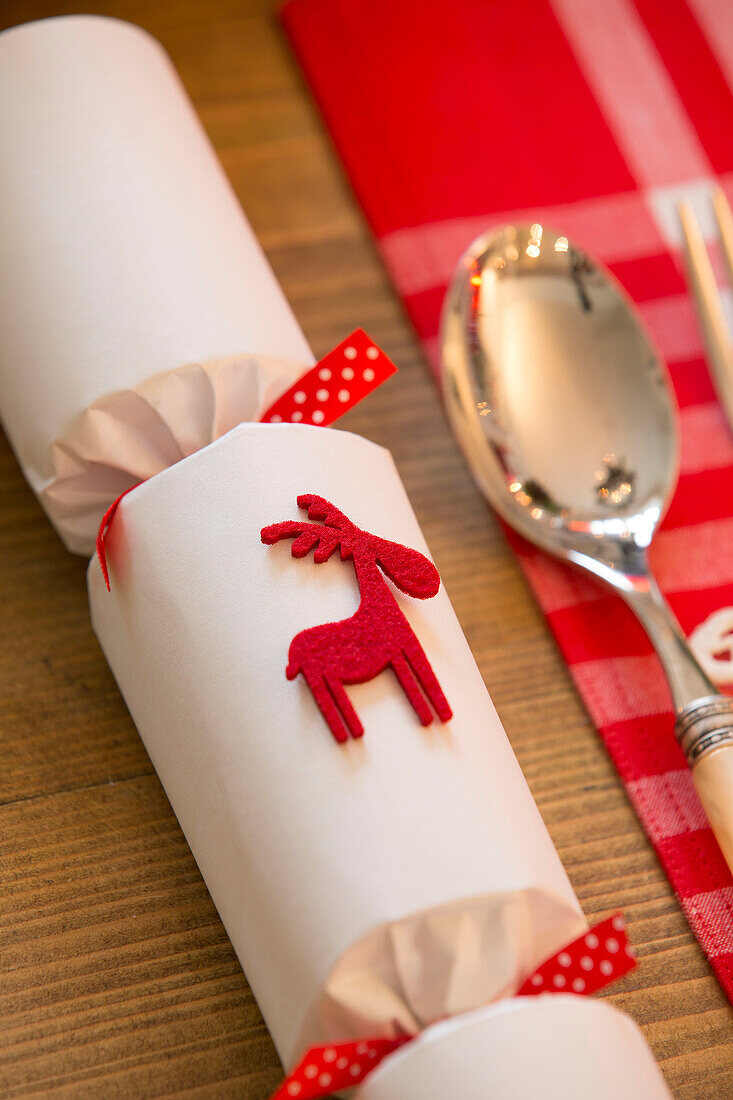 Christmas cracker with spoon on dining table in Surrey home   England   UK