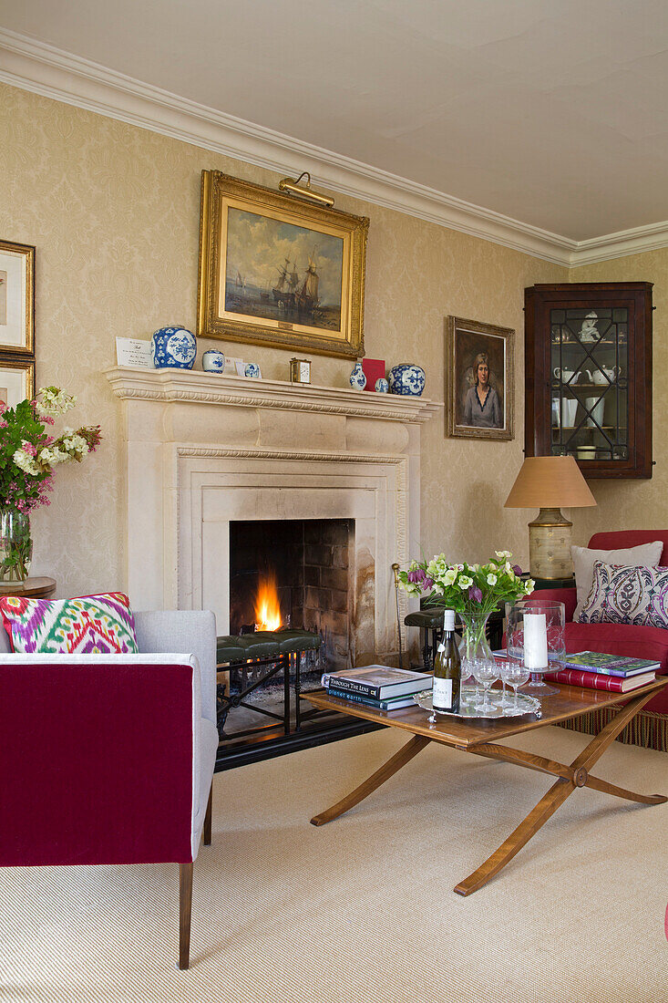 Gilt-framed artwork above lit fire in Warminster living room  Wiltshire  England  UK
