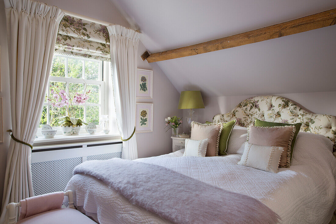 Wolldecke auf Doppelbett mit Orchidee im Fenster eines Hauses in Dorset England UK