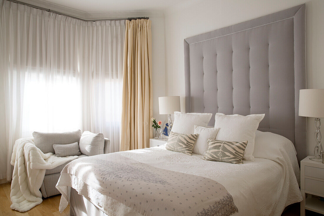 Light grey headboard above double bed in London townhouse UK