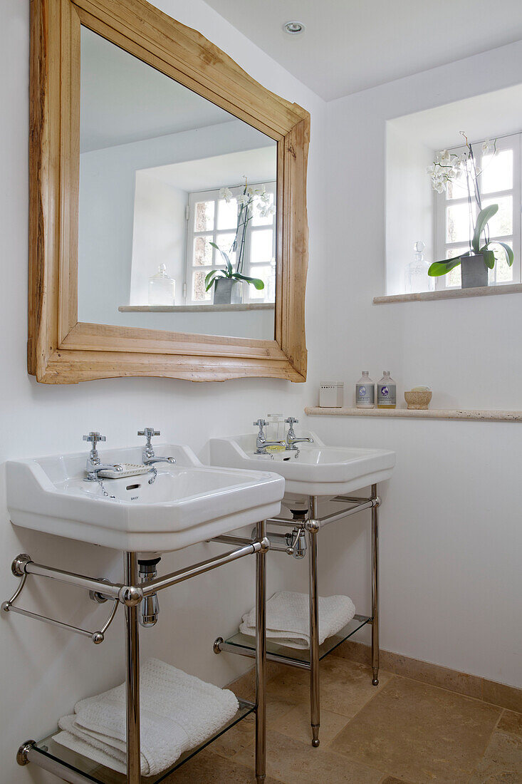 Large wood framed mirror above double basins in Var bathroom Provence France