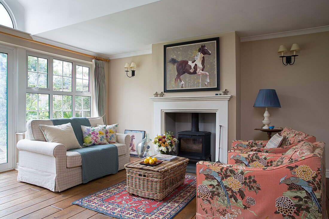 Equestrian artwork above fireplace in modernised living room of Georgian home Berkshire England UK