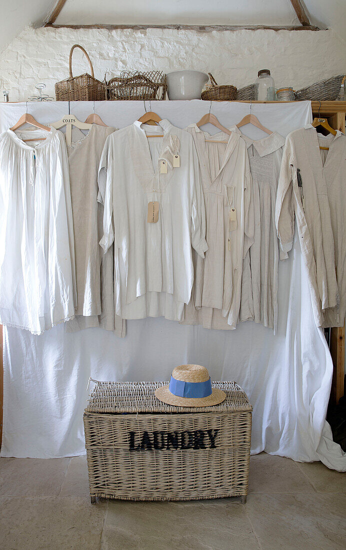 Antique nightshirt and laundry basket in renovated Victorian schoolhouse West Sussex England UK