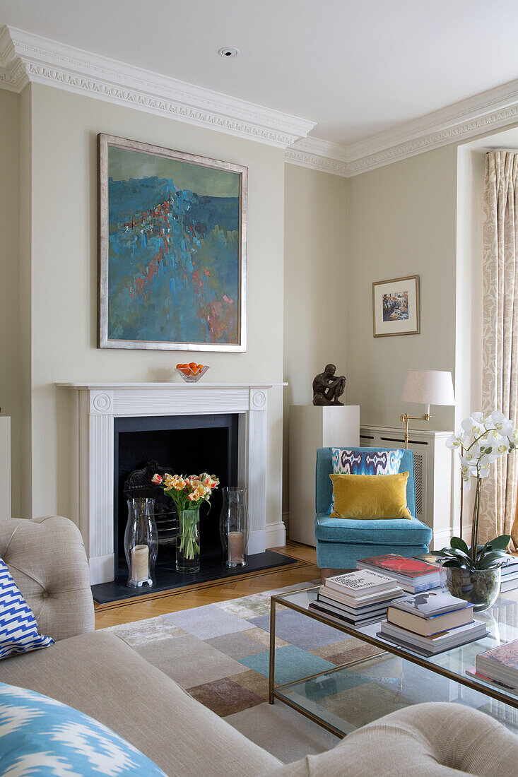 Modern artwork above fireplace in living room of Victorian terraced house London England UK