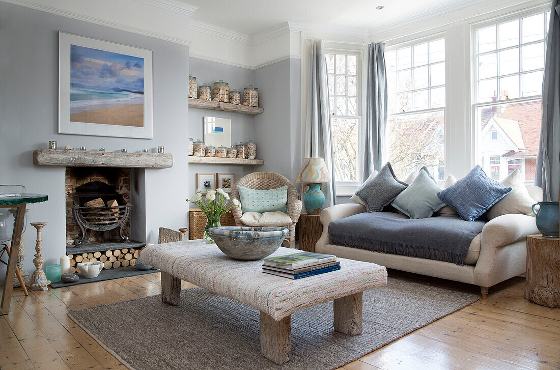Ottoman covered in antique Swedish rag rug fabric in neutral blue living room of Sussex home England UK