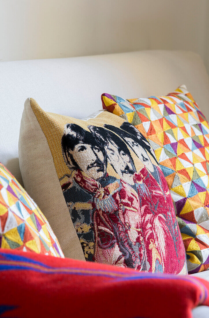Geometric and tapestry cushion of the Beatles in London townhouse England UK