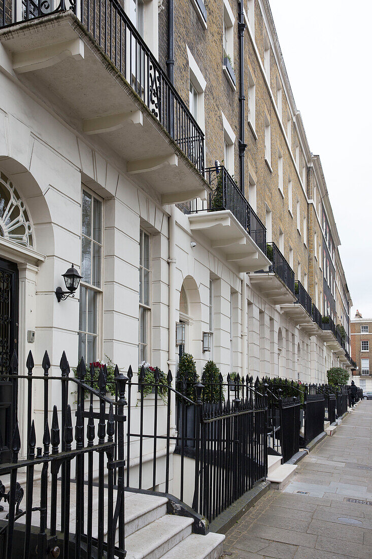 Wrought iron metal railings on exterior facade of London terraced townhouses UK