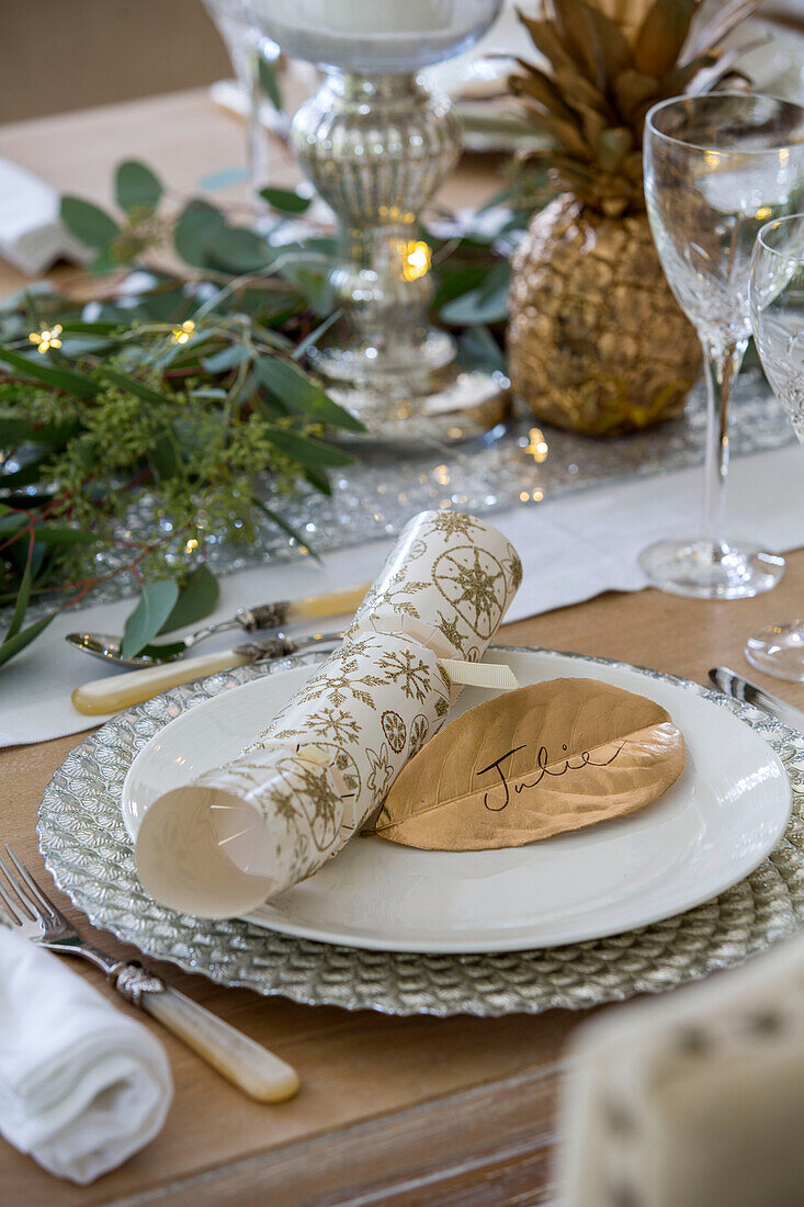 Christmas cracker at personalised place setting ion dining table in Kent England UK