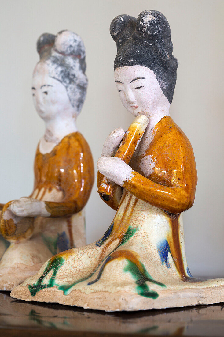 Zwei kniende Keramikfiguren von Musikern in einem Bauernhaus in Gloucestershire, England, UK