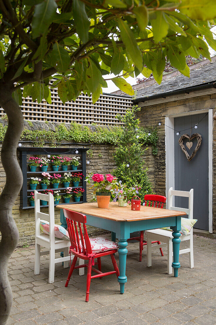 Tisch und Stühle im ummauerten Garten einer Villa in Brighouse, West Yorkshire UK