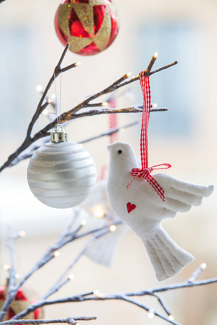 White dove with baubles on twig arrangement in London townhouse UK