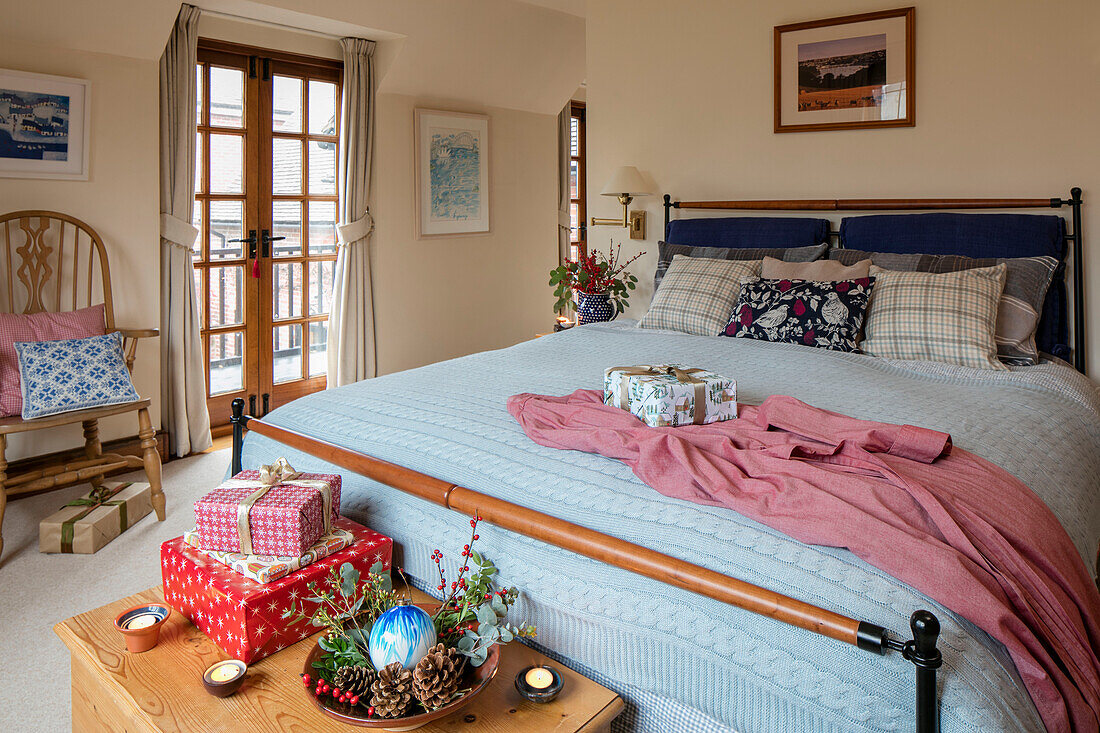 PInk bathrobe on double bed with Christmas presents in Berkshire home UK