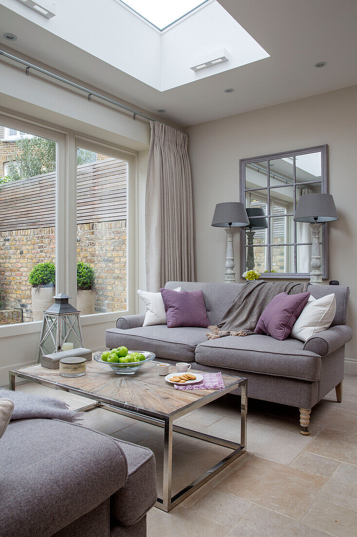 Two seater sofas under skylight in conservatory extension in London townhouse UK