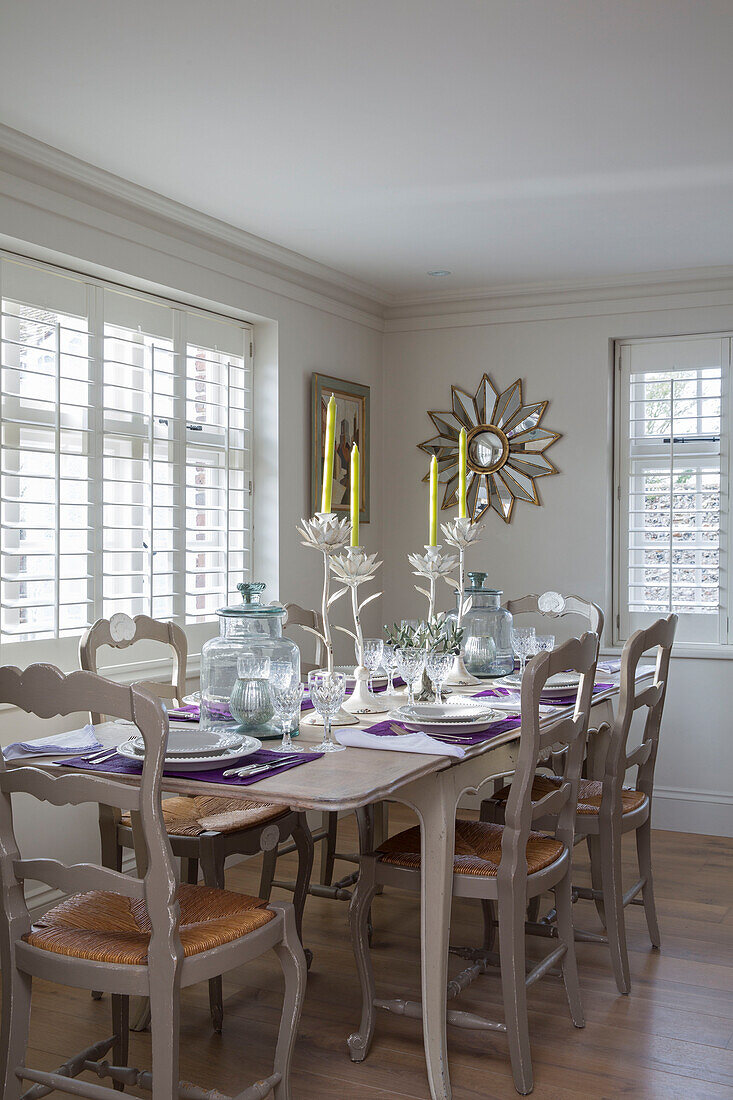 Painted chairs at dining table in West Sussex home